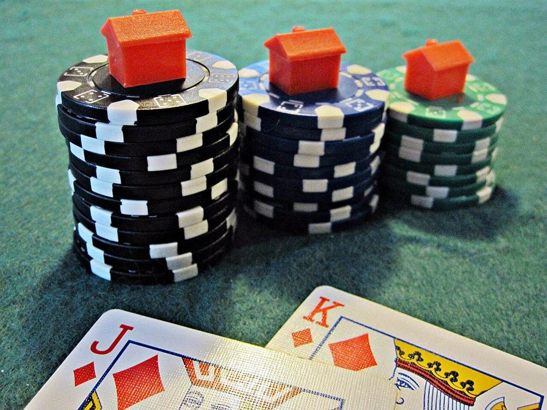 Tumpukan chip poker warna-warni di atas meja felt hijau
